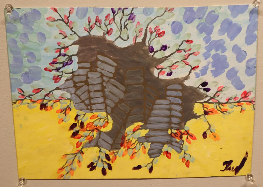 A child's painting of a ruined building with blossoming branches, in the blue and yellow of the Ukrainian flag
